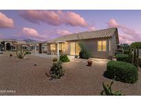 Desert landscaped backyard with covered patio and sliding glass doors for indoor/outdoor living at 6080 S Jojoba Ct, Gold Canyon, AZ 85118