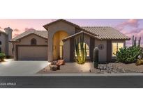 Charming single-story home featuring desert landscaping, a two-car garage, and a covered front entry at 6080 S Jojoba Ct, Gold Canyon, AZ 85118