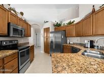 Spacious kitchen with stainless steel appliances, granite countertops, and ample cabinet space at 6080 S Jojoba Ct, Gold Canyon, AZ 85118