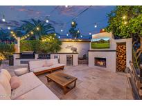 Resort style backyard with outdoor kitchen, fireplace, TV, and comfortable lounge seating at 7821 N Via De La Sombre --, Scottsdale, AZ 85258