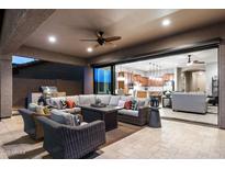 Relaxing covered patio with comfortable seating, an outdoor kitchen area, and seamless indoor-outdoor living at 8633 E Kael Cir, Mesa, AZ 85207