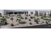 Modern exterior view showcasing desert landscaping and a contemporary design with a three-car garage at 9002 E Havasupai Dr, Scottsdale, AZ 85255