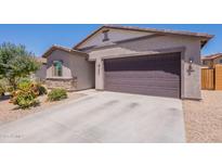 Charming single-story home featuring a two-car garage, desert landscaping, and neutral earth tone colors at 948 E Wiley Way, Casa Grande, AZ 85122