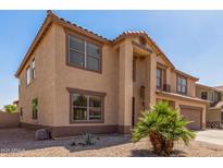 Two-story home featuring a neutral stucco exterior, a two-car garage, and a low-maintenance desert landscape at 11511 E Renata Ave, Mesa, AZ 85212