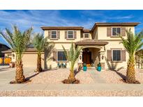 Two-story home with desert landscaping, covered entry, decorative shutters, and a charming walkway at 11737 N 143Rd Dr, Surprise, AZ 85379