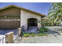 Charming home entrance featuring an arched brick entryway and decorative tilework at 1191 E Avenida Fresca St, Casa Grande, AZ 85122