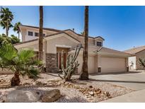 Charming two-story home with a desert landscape and attached three car garage at 13599 W Monte Vista Rd, Goodyear, AZ 85395