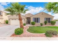 Inviting single-story home featuring a two car garage, desert landscaping and a mature palm tree at 139 E Gail Dr, Gilbert, AZ 85296