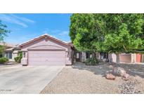 Charming single-story home with a two car garage and desert landscaping at 15740 N 91St Dr, Peoria, AZ 85382