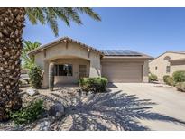 Charming single-story home featuring desert landscaping, solar panels, and a two-car garage at 16186 W Port Royale Ln, Surprise, AZ 85379