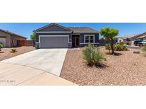 Charming single-story home featuring a two-car garage and low-maintenance desert landscaping at 30388 N Opal Dr, San Tan Valley, AZ 85143