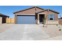 Charming single-story home featuring a spacious driveway and blue accent garage door and shuttered window at 311 S San Gregorio Ln, Casa Grande, AZ 85194