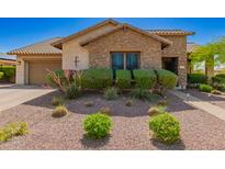 Charming single-Gathering home featuring a stone facade, desert landscaping, and a two-car garage at 3331 N Acacia Way, Buckeye, AZ 85396
