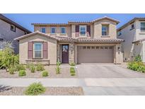 Charming two-story home featuring a tile roof and a welcoming front yard with desert landscaping at 4607 S Venus --, Mesa, AZ 85212