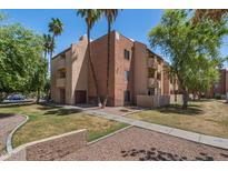 Condo exterior showing balconies, desert landscaping, and mature trees at 540 N May -- # 2148, Mesa, AZ 85201