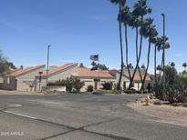 View of the Arrowhead Lakes community entrance with desert landscaping and charming architecture at 7101 W Beardsley Rd # 422, Glendale, AZ 85308