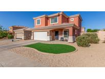 Charming two-story home with artificial turf, desert landscaping, and a two-car garage at 7227 S 13Th Way, Phoenix, AZ 85042