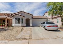 Charming single-story home with a low-maintenance desert landscape and a two-car garage at 9124 W Williams St, Tolleson, AZ 85353
