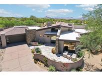 Stunning desert home showcasing custom stone, modern architecture and a serene outdoor patio with mountain views at 10651 E Fernwood Ln, Scottsdale, AZ 85262