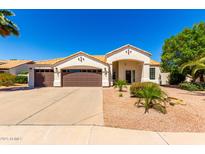 Charming single-story home featuring a three-car garage, desert landscaping, and a well-maintained front yard at 1710 S Aaron --, Mesa, AZ 85209