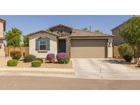 Charming single-story home featuring stone accents, desert landscaping, and a two-car garage at 17178 W Buchanan St, Goodyear, AZ 85338