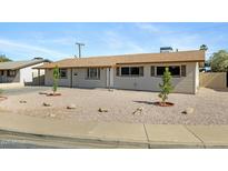 Charming single-story home with neutral colored exterior and desert landscaping at 2030 E Alder Cir, Mesa, AZ 85204