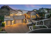 Stunning two-story stone home with a three-car garage, manicured landscaping, and elegant architectural details at 4366 S Avenida De Angeles --, Gold Canyon, AZ 85118
