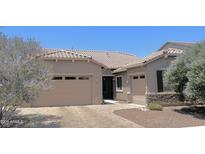 Charming single-story home featuring a paved driveway, attached garage, and desert landscaping at 4956 S Leisure Way, Gilbert, AZ 85298