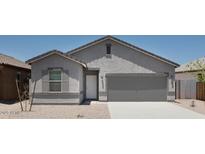 Charming single-story home with desert landscaping, neutral color palette, and an attached two-car garage at 5768 S 242Nd Ln, Buckeye, AZ 85326