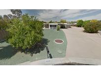 Well-maintained single-story home with mature trees and a mailbox at 8632 E Delilah Ave, Mesa, AZ 85208