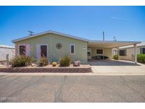 Inviting single-story home featuring a covered carport and desert landscaping at 9822 E Main St # 4, Mesa, AZ 85207