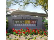 Sign for Frank's on Shea Condominiums with well maintained landscaping, and assigned covered parking in the background at 11375 E Sahuaro Dr # 1053, Scottsdale, AZ 85259