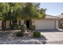 Charming single story home with a well maintained front yard, mature trees and two car garage at 12044 S 45Th St, Phoenix, AZ 85044