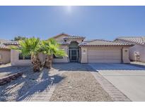 Charming single-story home featuring desert landscaping, a two-car garage, and covered entry at 15360 N 87Th Ave, Peoria, AZ 85381