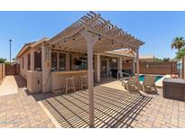 Beautiful backyard with a bar, pergola and plenty of room for entertaining at 18080 W Spencer Dr, Surprise, AZ 85374