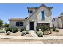 Charming two-story home featuring stone accents and a well-maintained gravel landscaped front yard at 2539 N 148Th Dr, Goodyear, AZ 85395