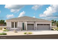 Charming single-story home featuring a three-car garage and decorative stone accents at 27611 N 176Th Dr, Surprise, AZ 85387