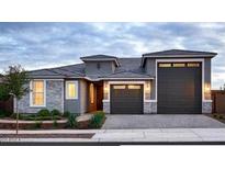Charming single-story home featuring a two-car garage, stone accents, and a well-maintained landscaped front yard at 27665 N 176Th Dr, Surprise, AZ 85387
