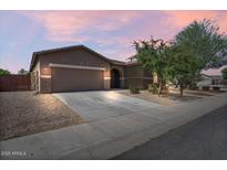 Charming single-story home featuring a neutral color palette, desert landscaping, and a two car garage at 4125 W Gary Way, Laveen, AZ 85339