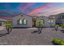 Charming single-story home with desert landscaping, arched windows, and elegant architectural details at 9345 W Robin Ln, Peoria, AZ 85383