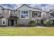 Charming two-story home with a well-manicured lawn and inviting front porch at 11300 N Casa Dega Dr # 1019, Surprise, AZ 85388