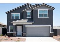 Charming two-story home featuring a two-car garage and classic architectural details at 15511 W Deanne Dr, Waddell, AZ 85355