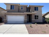 Inviting two-story home featuring a neutral color scheme, attached two-car garage, and low maintenance landscaping at 17493 W Fulton St, Goodyear, AZ 85338