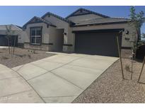 Charming single-story home featuring a stone facade, neutral colors, and a spacious two-car garage at 17738 W Onyx Ave, Waddell, AZ 85355