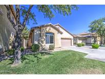 Charming single-story home with lush green lawn, mature tree, and a two-car garage at 1831 S Hudson Dr, Chandler, AZ 85286