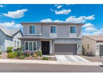 Charming two-story home with a two-car garage, landscaped yard, and a welcoming entrance at 21134 W Minnezona Ave, Buckeye, AZ 85396