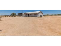 Charming single-story home featuring a metal roof and low-maintenance landscaping at 22578 E Sahara Dr, Florence, AZ 85132