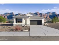 Charming single-story home with a two-car garage, desert landscaping, and mountain views at 22580 N Lynn St, Maricopa, AZ 85138