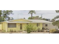 Charming yellow home featuring a well-maintained front yard and a classic single-story design at 344 E Taylor St, Tempe, AZ 85288