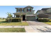 Charming two-story home featuring a brick driveway, attached two car garage, and lush green lawn at 3818 E Appaloosa Rd, Gilbert, AZ 85296